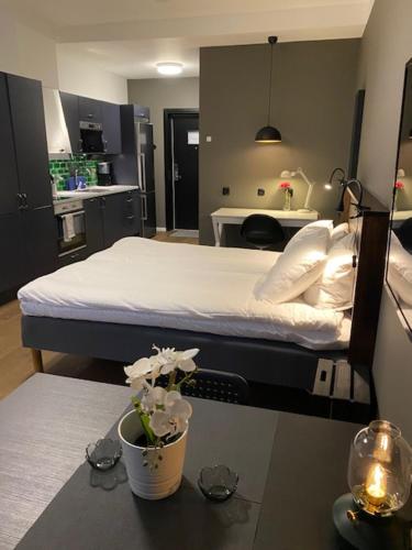 a hospital room with a bed and a table with flowers at Magnolia House Norrviken in Sollentuna