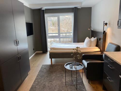 a small bedroom with a bed and a window at Magnolia House Norrviken in Sollentuna