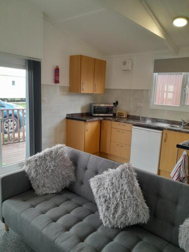 a living room with a couch in a kitchen at Perfect chalet to relax in k4 in Mablethorpe