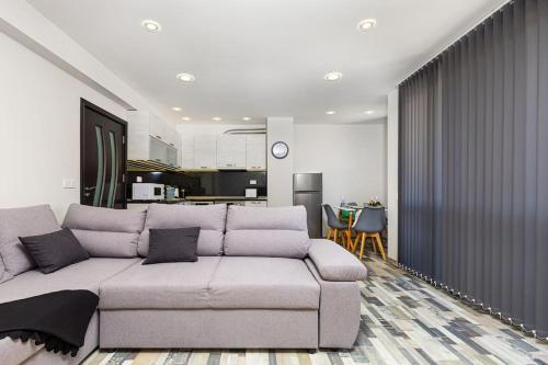 a living room with a couch and a kitchen at Florance flat next to Old Town & City Center NEW in Plovdiv