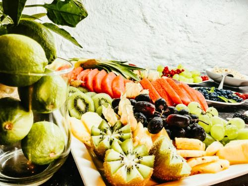 a buffet of fruit and vegetables on a table at Atlas Grand Hotel in Garmisch-Partenkirchen