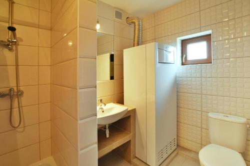 a bathroom with a toilet and a sink at Comfortable holiday home with a nice garden, close to the sea, Sarbinowo in Sarbinowo