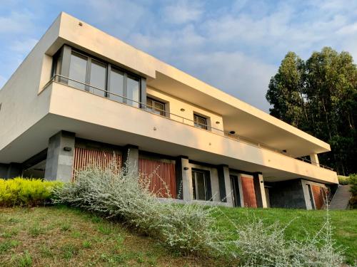 a house on top of a grassy hill at Soleada in Gijón