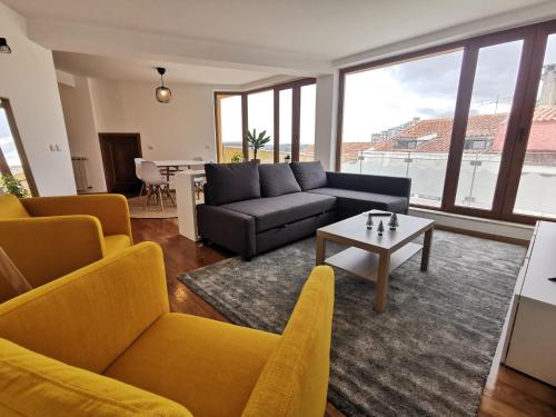 a living room with a couch and a table at Alta Guesthouse in Coimbra