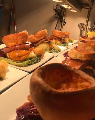 a buffet of sandwiches and other foods on plates at Red Lion Coaching Inn in Redbourne