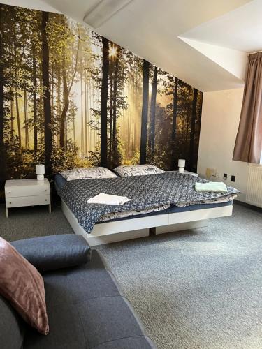 a bedroom with a bed with a forest wall mural at GRAN hostel in Banská Bystrica