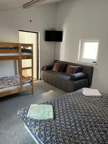a living room with a couch and a bed at GRAN hostel in Banská Bystrica