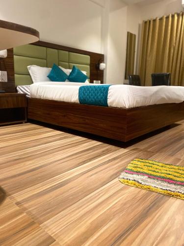 a bedroom with a bed and a rug on the floor at Hotel Candor Amigo Airoli Mind Space in Navi Mumbai