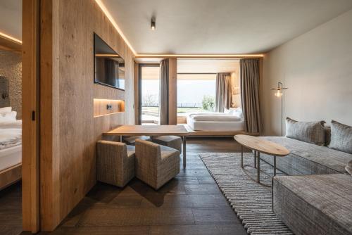 a living room with a couch and a table at Santre dolomythic home in Bressanone