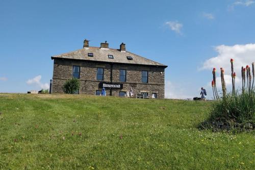 a building on top of a grassy hill at Beauview Brand New For 2023 Wi-Fi and Smart TV in Millom