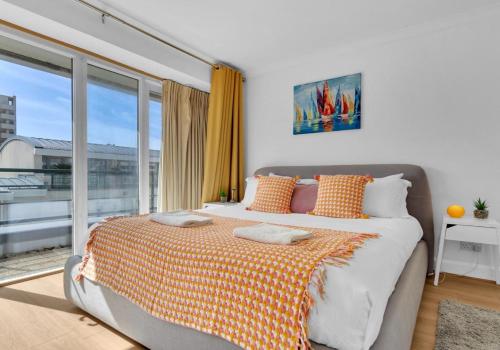 a bedroom with a bed and a large window at Golden Sunset House Free Parking By My Getaways in Brighton & Hove