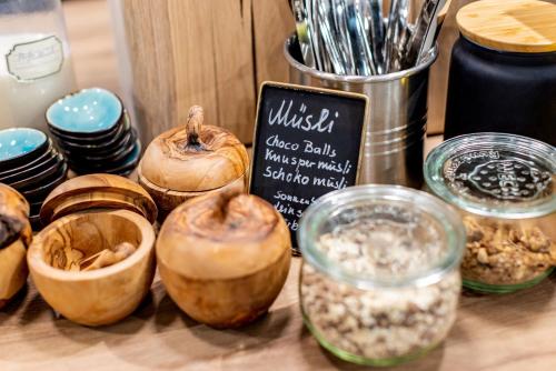 a table with bowls of food and a sign at BOLLWERK Lifestyle Hotel, automatisiertes Hotel mit Self Check In in Immenstadt im Allgäu