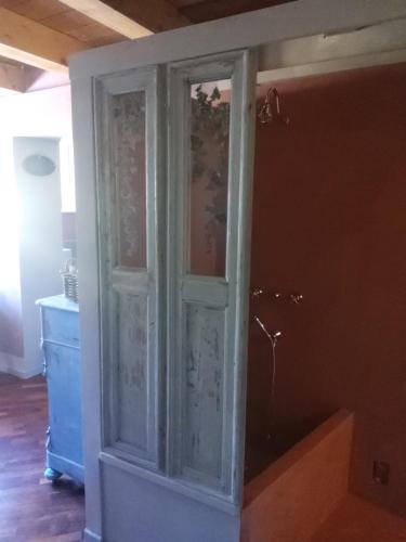 a glass cabinet in the corner of a room at Relais B in Ancona