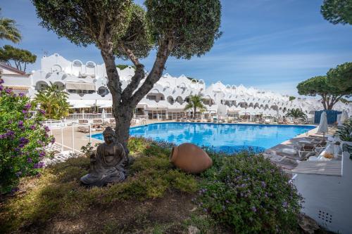 a statue next to a swimming pool at a resort at Casa Hibiscus Marbella in Marbella