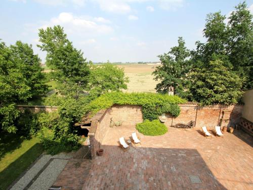 an overhead view of a patio with white benches at Apartment near Cremona in Historic Convent in Stagno Lombardo