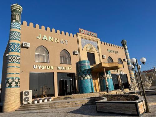 a building with two towers on a street at Jannat Minor Boutique Hotel in Urganch