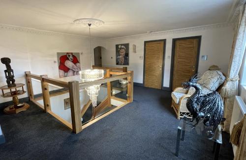 a living room with a table and a chair at The Waters Edge Guest House in Stratford-upon-Avon