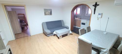 a living room with a chair and a table at Apartman Progresso in Valjevo