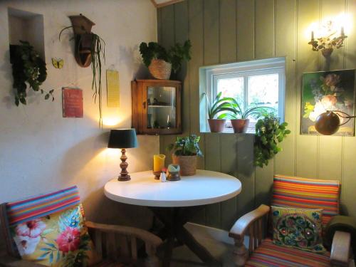 a room with a table and two chairs and a window at Zintuinen in Esbeek