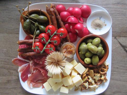 a plate of food with different types of fruits and vegetables at Zintuinen in Esbeek