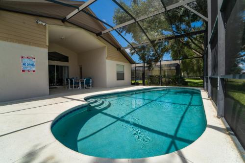 a swimming pool in the backyard of a house at 16150EGRET- Sun Chaser (S) in Orlando