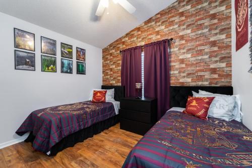 a bedroom with two beds and a brick wall at 16150EGRET- Sun Chaser (S) in Orlando