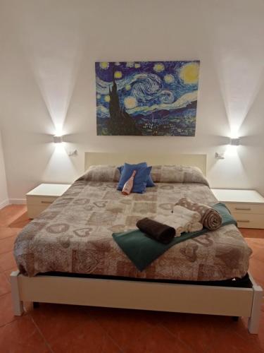a bedroom with a bed with a painting on the wall at Da Anna e Michele in Andria