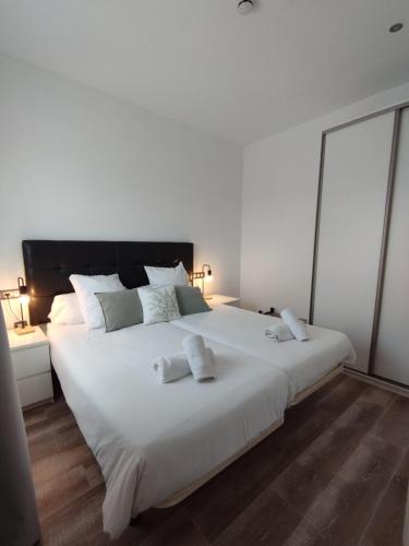 a large white bed with two white towels on it at Mater Ariany in Ariany