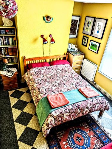 a bedroom with a bed with a colorful bedspread at 6 Park Terrace in Glastonbury