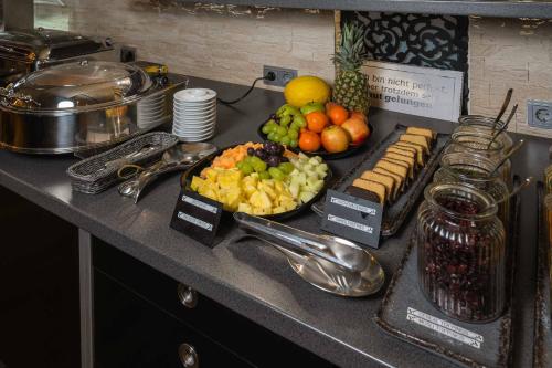a buffet of fruit and vegetables on a counter at PLAZA INN Heilbronn in Heilbronn