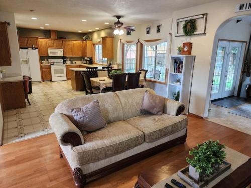 a living room with a couch and a kitchen at A Wine Country Home in Yamhill County in Lafayette