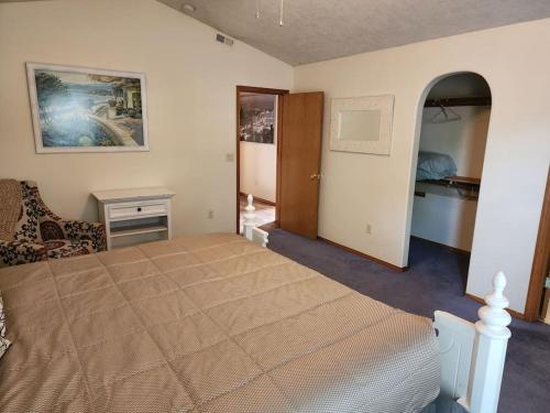 a bedroom with a large bed and a doorway at A Wine Country Home in Yamhill County in Lafayette