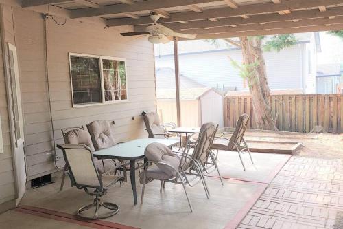a patio with tables and chairs on a porch at A Wine Country Home in Yamhill County in Lafayette