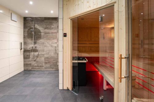 a bathroom with a shower and a sink and a shower stall at PLAZA INN Heilbronn in Heilbronn