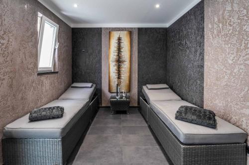 a room with two beds and a window at PLAZA INN Heilbronn in Heilbronn