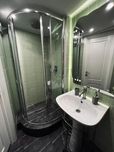 a bathroom with a sink and a shower at Kyiv Art Apartments near Golden Gate in Kyiv