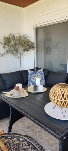 a table with candles on top of a couch at Kamiros Apartment in Kalavárda