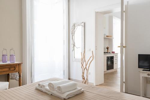 a bedroom with two towels on a bed with a mirror at Guest House Sicily in Syracuse