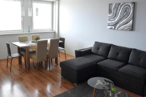 a living room with a couch and a table at Panorama View Apartment in Veszprém
