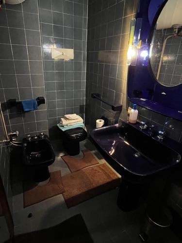 a bathroom with a sink and a toilet and a mirror at Italian Alps gateway - Huge, Comfortable place! in Passo del Tonale