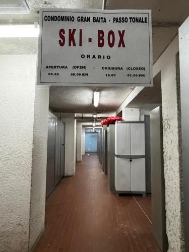 a sign for a skil box in a building at Italian Alps gateway - Huge, Comfortable place! in Passo del Tonale