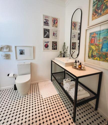 a bathroom with a sink and a toilet and a mirror at 1 Royal Street Guesthouse in Riebeek-Kasteel