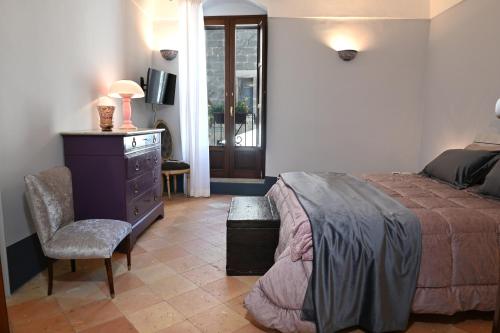 a bedroom with a bed and a chair and a window at Rachel's House in Altamura