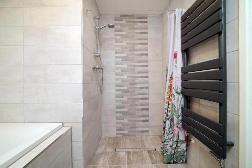 a bathroom with a shower with a shower curtain at Grove Lodge, Contemporary Cabin in Mendip Hills in Axbridge