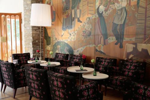 uma sala de jantar com mesas e cadeiras e um mural em Design Hotel Miramonte em Bad Gastein