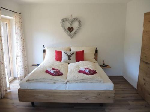ein Schlafzimmer mit einem Bett mit roten Kissen darauf in der Unterkunft Ferienwohnung Ochsenhorn in Lofer 100 m² / 4-8 P. in Lofer