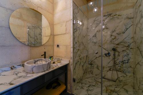 a bathroom with a sink and a shower at The Niche Cave Hotel in Goreme