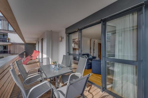 a dining room with a table and chairs at Alpin & See Resort - Pinzgau Holidays in Zell am See