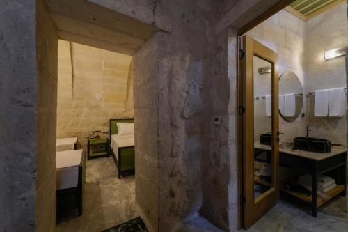 a bathroom with two sinks and a large mirror at The Niche Cave Hotel in Goreme