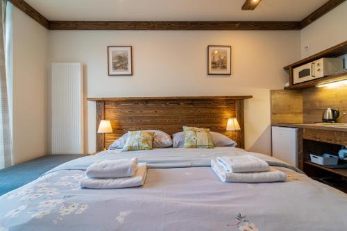 a bedroom with a large bed with two pillows on it at Apartmány Veternica v Bernarde in Smokovce